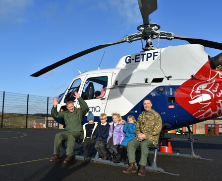 Children from aerheart class posing with squadron leaders garry mckary and liam glasby