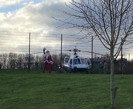 Santa waving at st michaels pupils after arriving in the helicopter